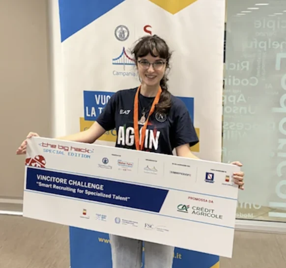 Claudia holding the winner's banner of The Big Hack for Crédit Agricole, Naples 2025